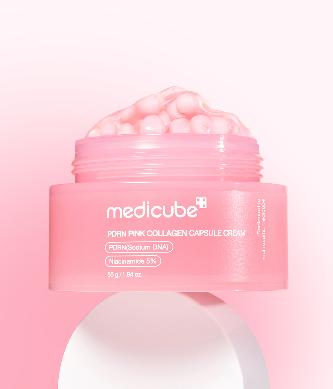 Pink medical capsules arranged for a beauty and wellness product concept