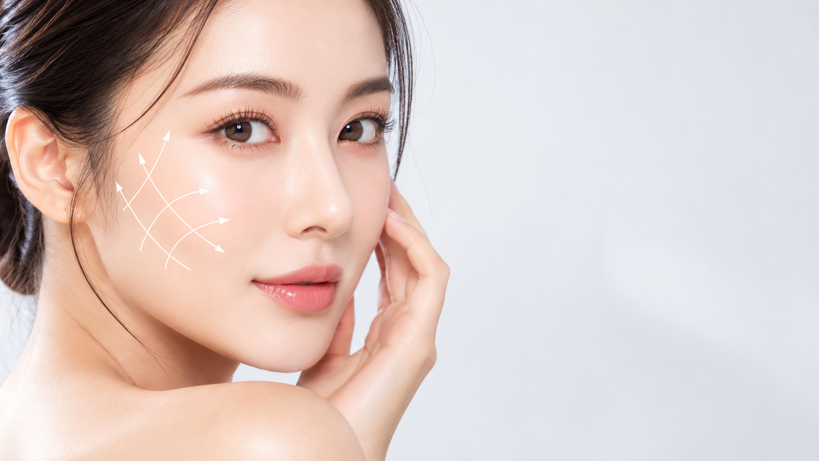 Model with arrows drawn on her cheek to illustrate skin lifting and tightening