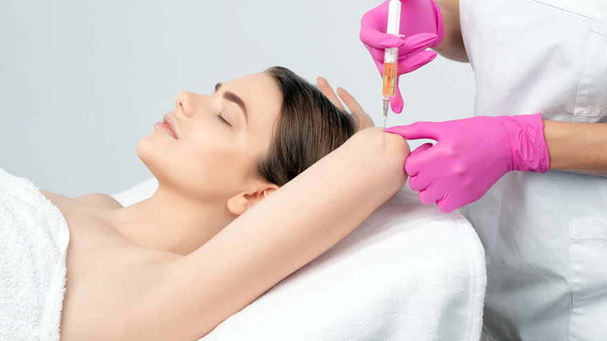 Practitioner giving an underarm injection to reduce excessive sweating