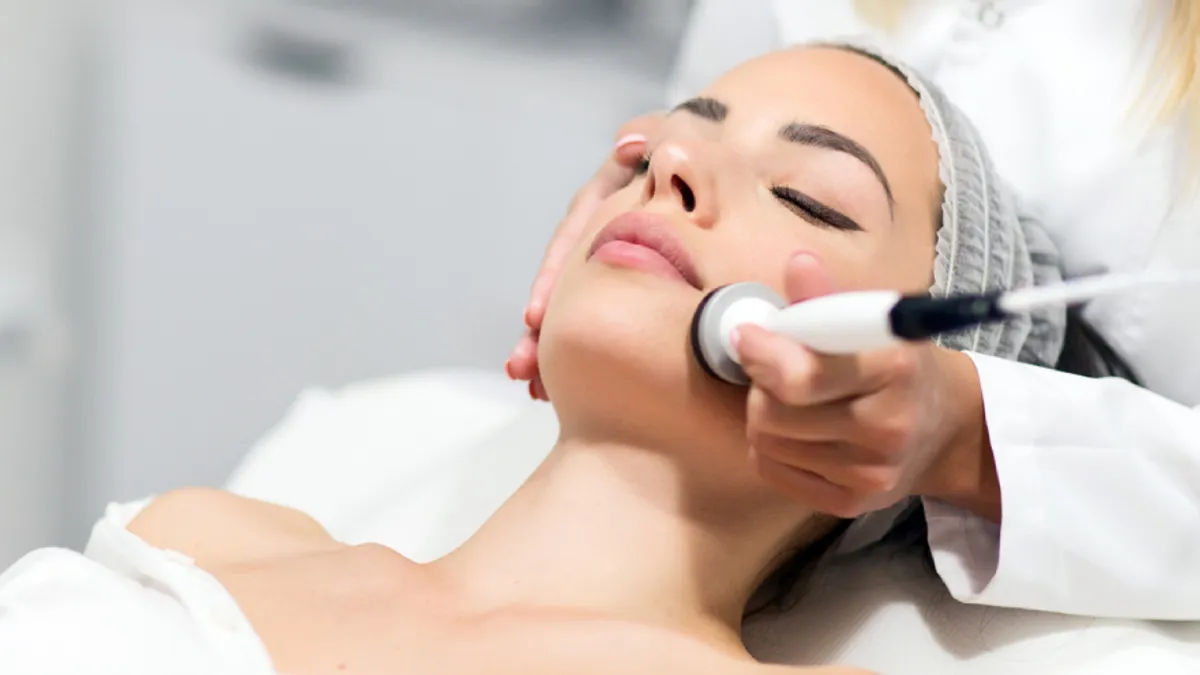 Woman receiving ONDA Lifting microwave-based skin tightening treatment on her face