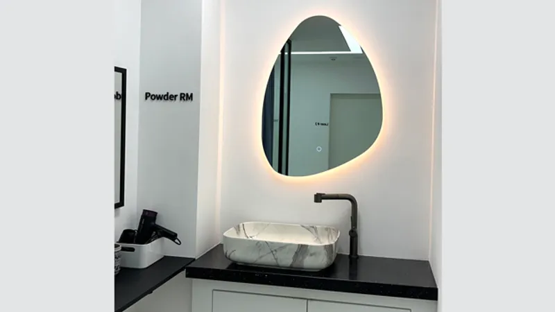 Powder room sink and illuminated mirror at Doctorpetit Hongdae.