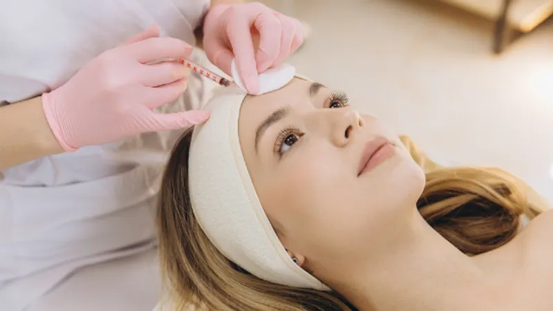 Woman receiving Botox injections to reduce facial wrinkles and fine lines