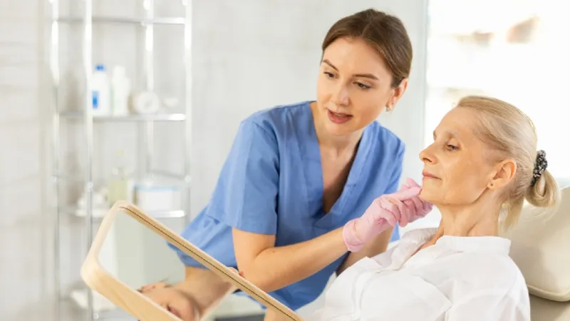 Clinician assessing facial structure and jawline skin laxity during lifting consultation