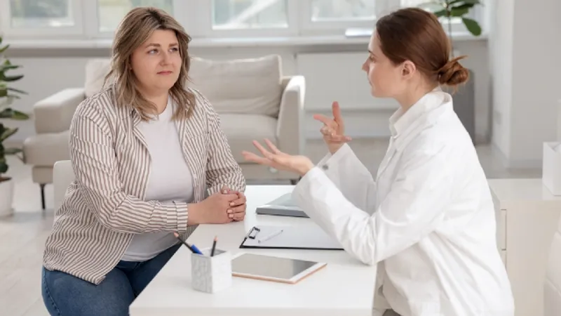 In-person consultation assessing skin elasticity and fat distribution for body contouring
