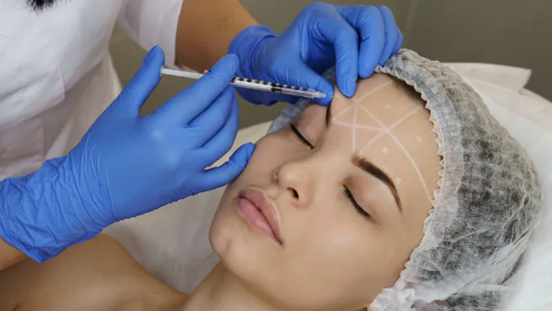 Brow lift procedure — doctor injecting near patient