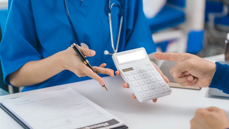 Doctor explaining ptosis correction costs and treatment details to a patient during a consultation.
