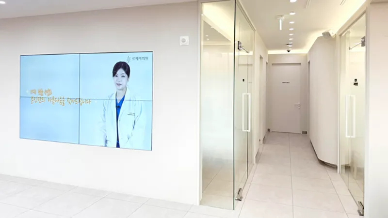 Hallway at Le.J Plastic Surgery with glass treatment room doors.