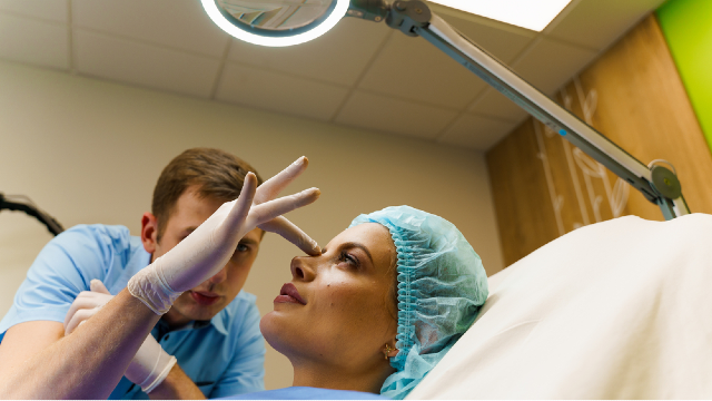 Cosmetic surgeon evaluating facial proportions and nasal structure during a revision rhinoplasty consultation