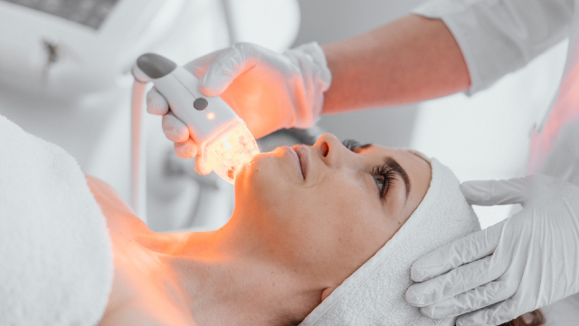 Non-surgical skin rejuvenation treatment using light therapy device performed by a medical professional