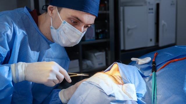 Surgeon operating on a patient's nose during a rhinoplasty procedure