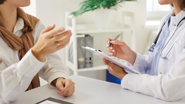 Doctor discussing rhinoplasty treatment plans and costs with a patient during a consultation.
