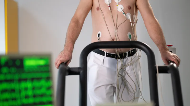 Patient undergoing autonomic nervous system testing while a clinician monitors physiological signals on a tablet.